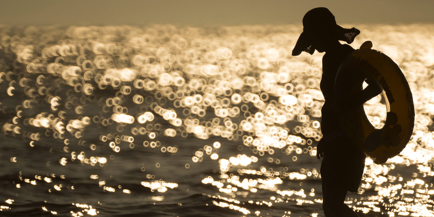 busan-beach-swimmer-hat-water-sunset